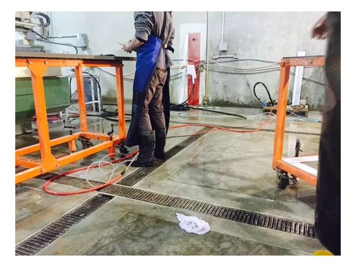 Metal trench drain grate set in a commercial floor