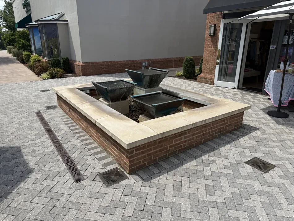 Finished paver patio with integrated drainage and fountain
