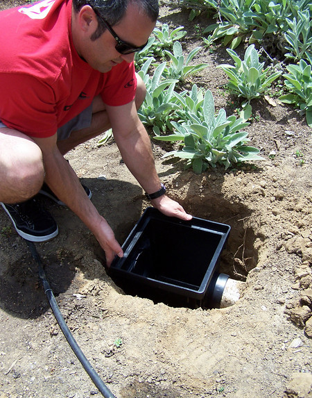 Catch basin installed flush with the ground to collect surface runoff