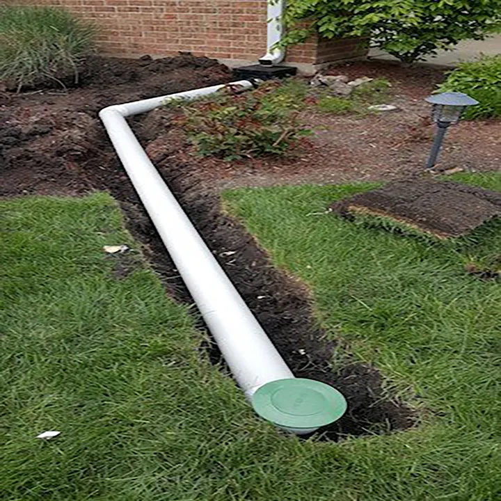 Downspout piped underground to a pop-up emitter at the lawn edge